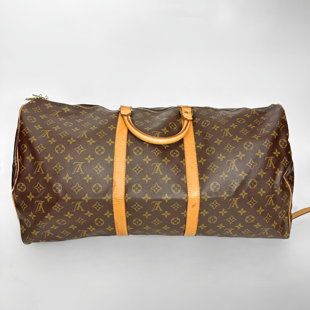 Brown travel bag with yellow handles on a light gray background