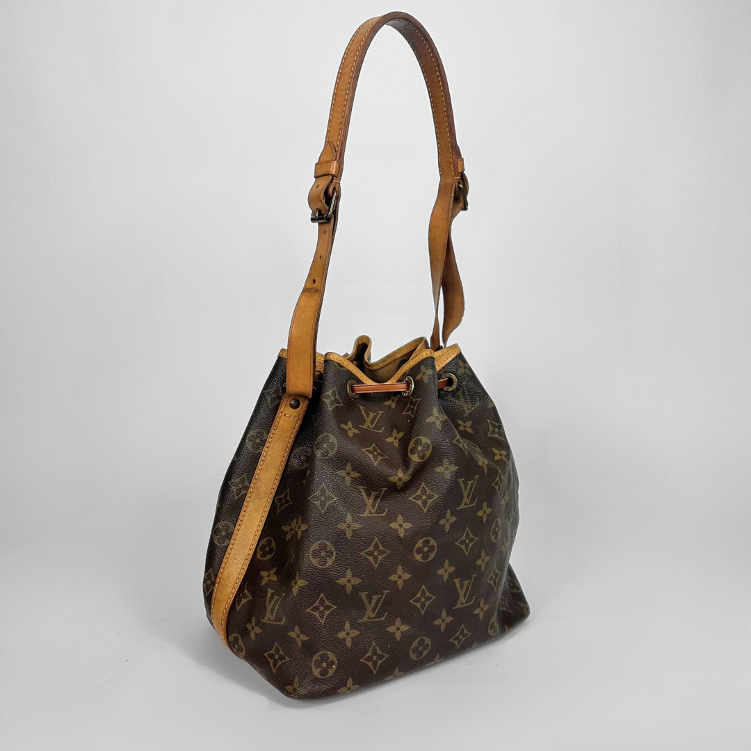 Designer handbag with monogram pattern on a light gray background