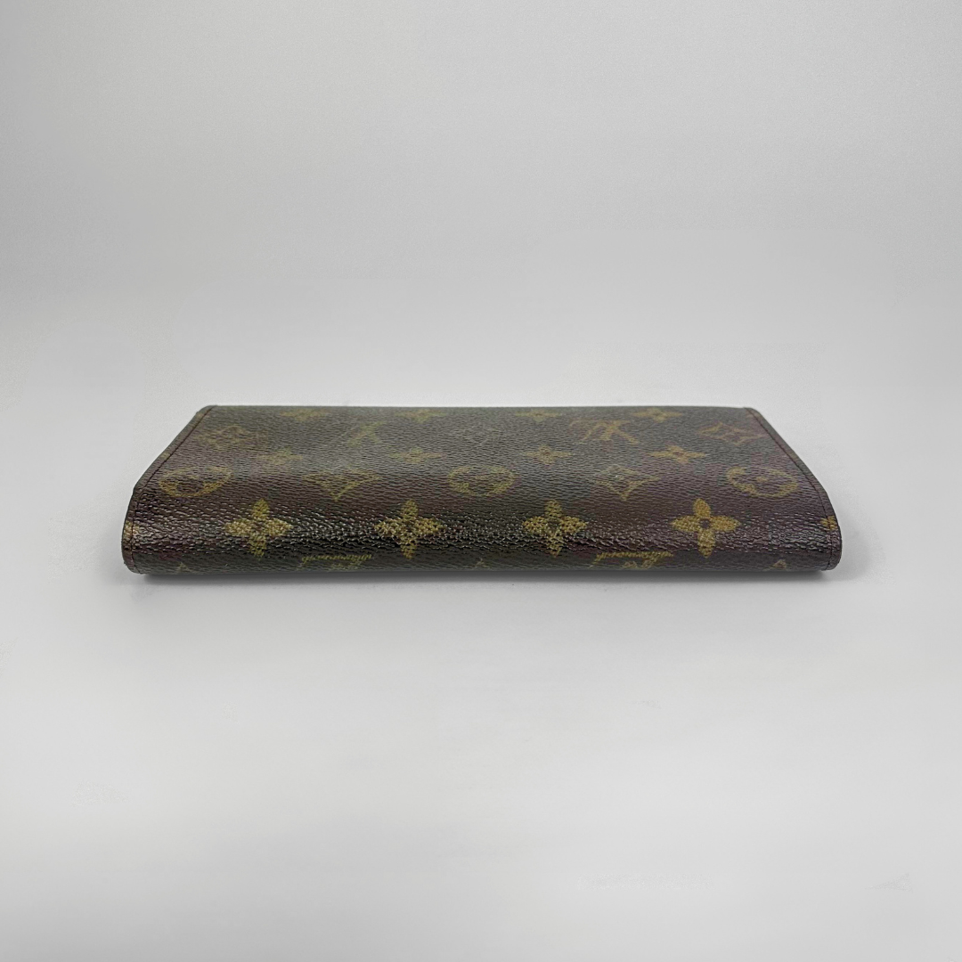 Louis Vuitton monogram clutch bag on a light gray background