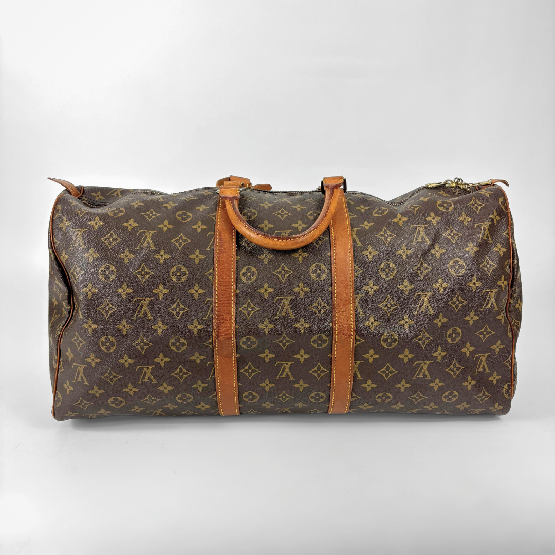 Brown Louis Vuitton travel bag with monogram pattern on a white background