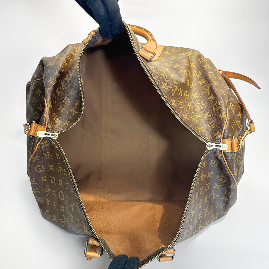 Brown monogram patterned bag with gold hardware on a white background
