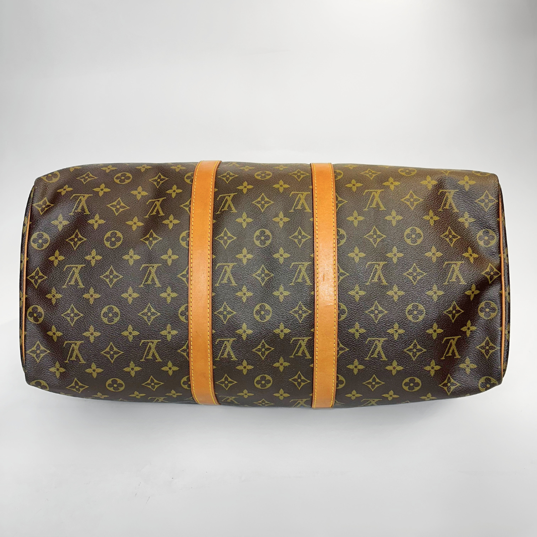 Brown travel bag with monogram pattern on a white background