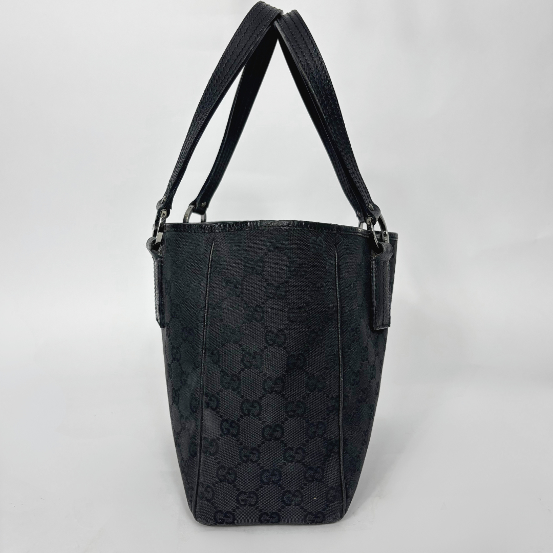 Black patterned handbag on a white background