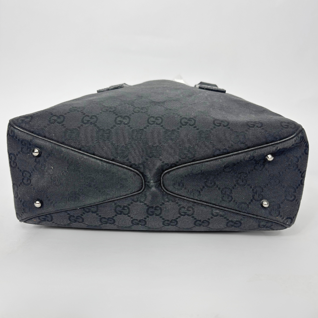Black patterned handbag on a white background