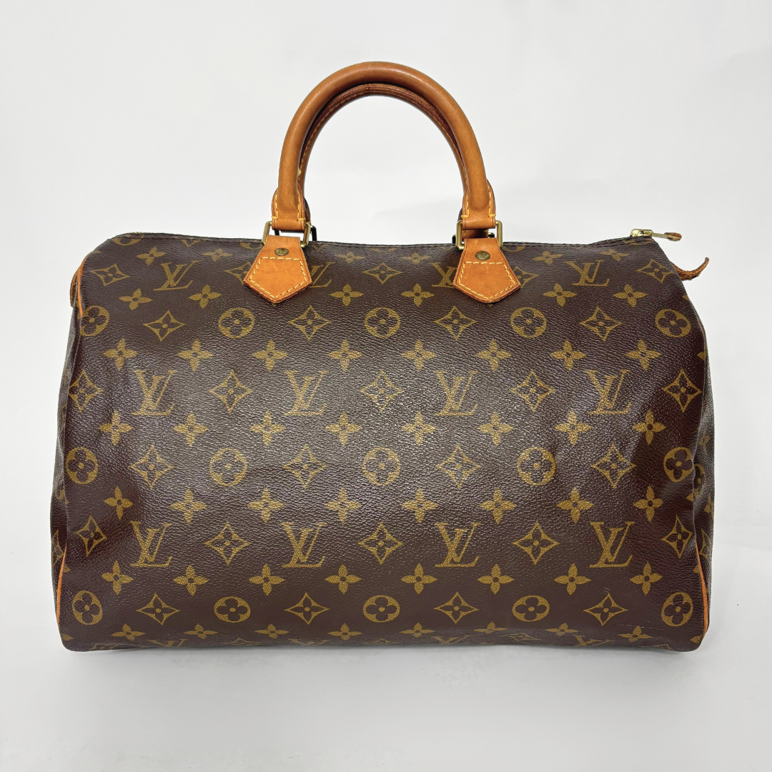 Brown handbag with monogram pattern on a white background
