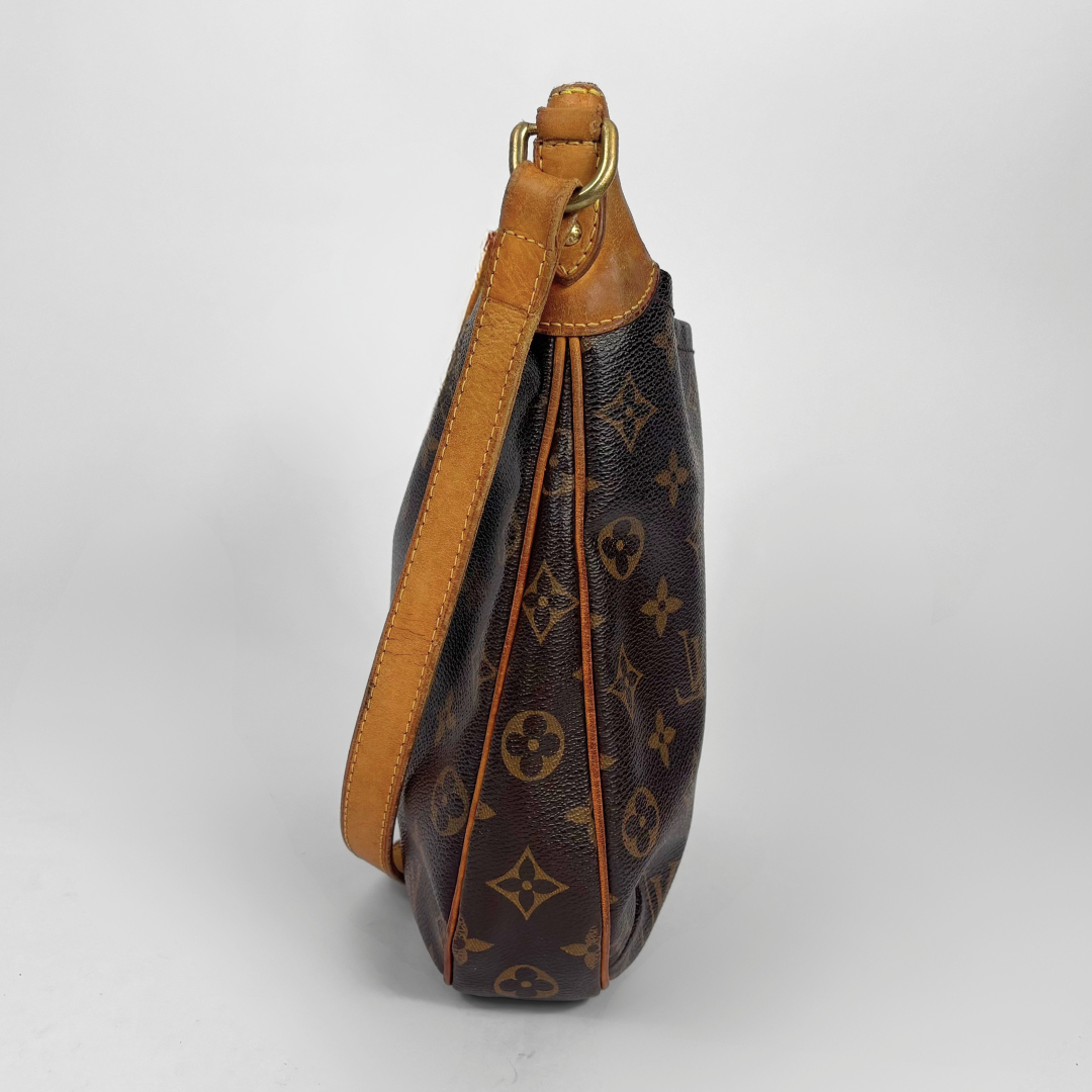 Brown leather handbag with visible brand logo on a white background