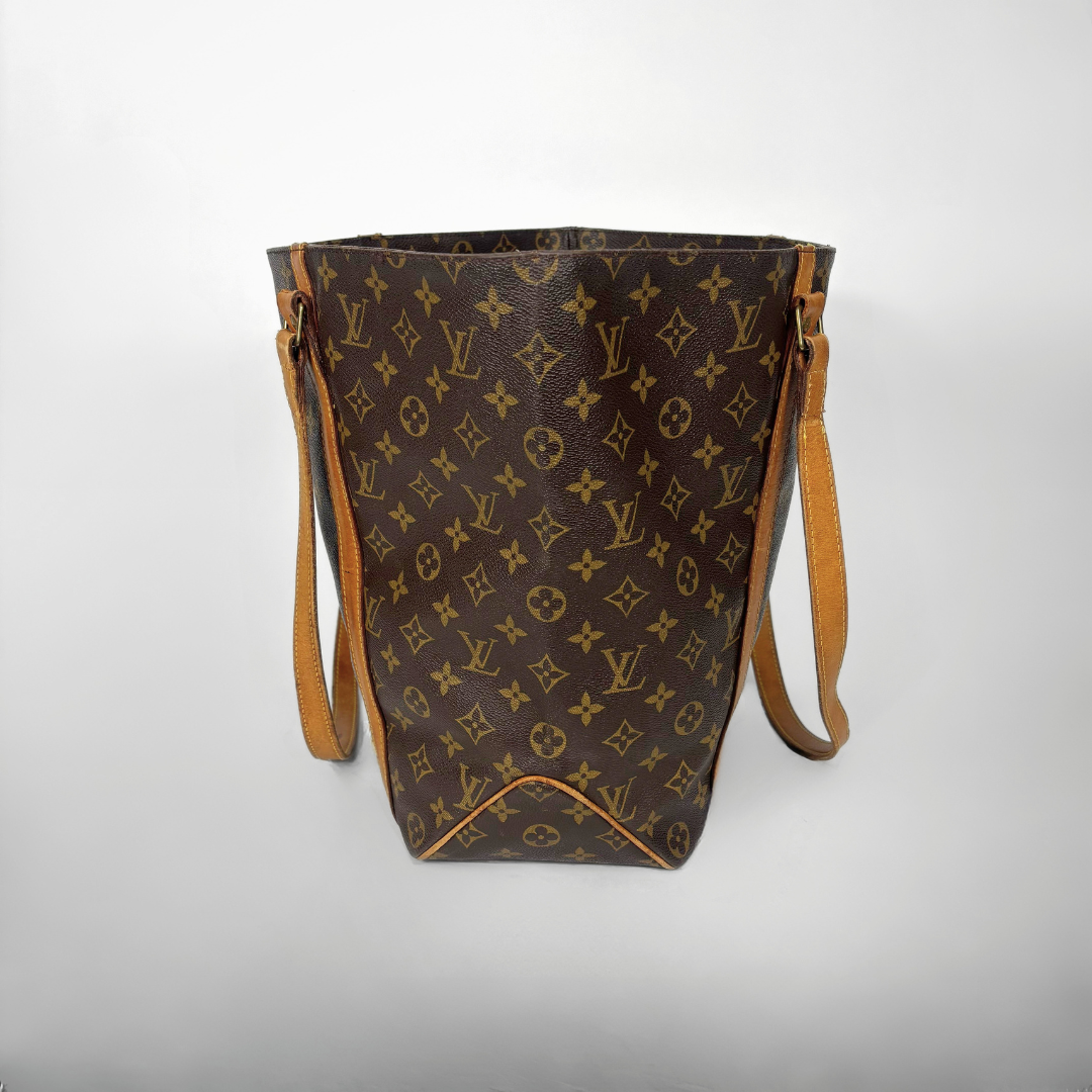 Brown handbag with monogram pattern on a white background