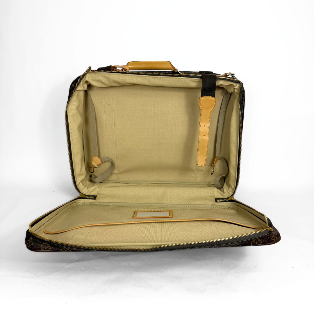 Open beige suitcase on a white background