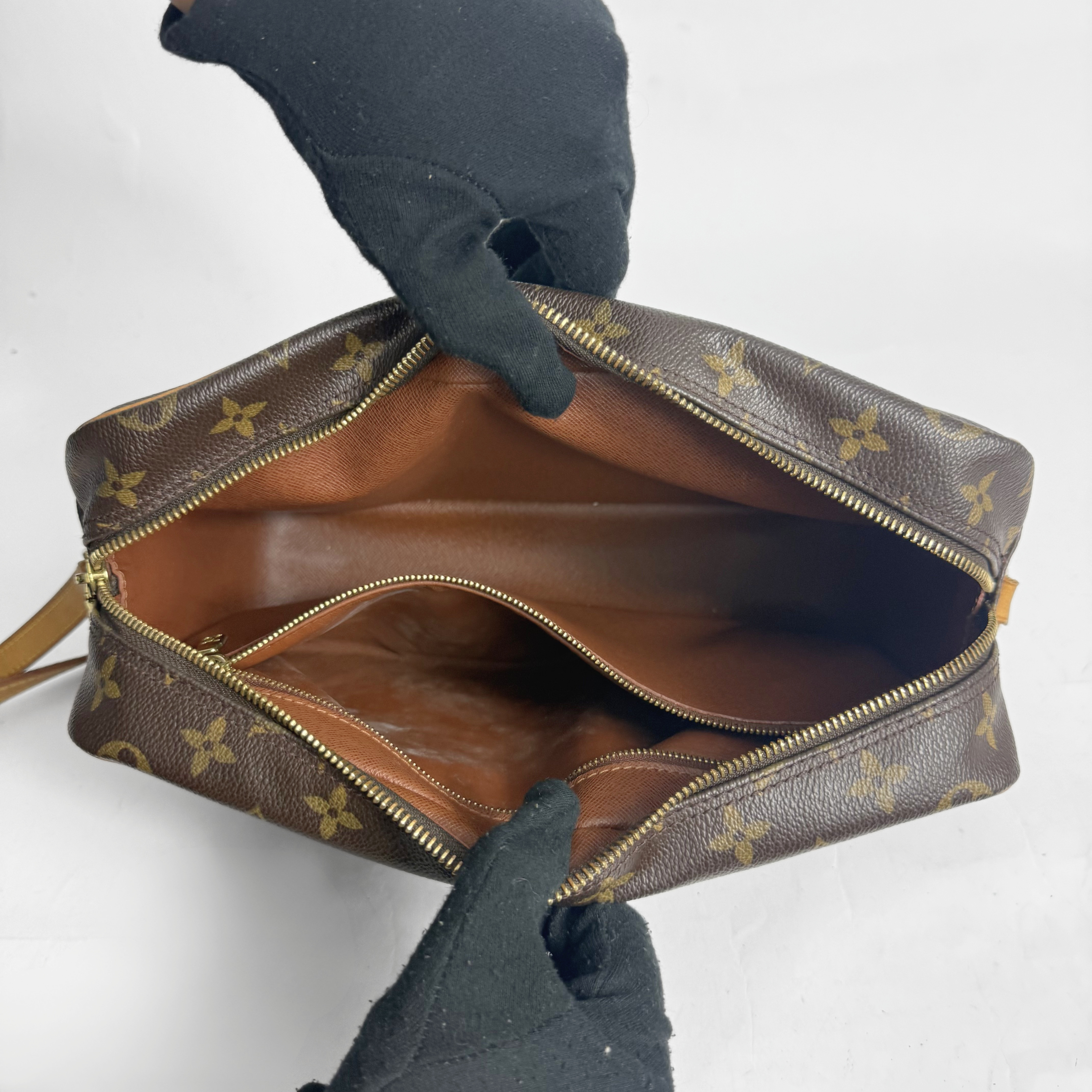 Brown handbag with gold monogram pattern